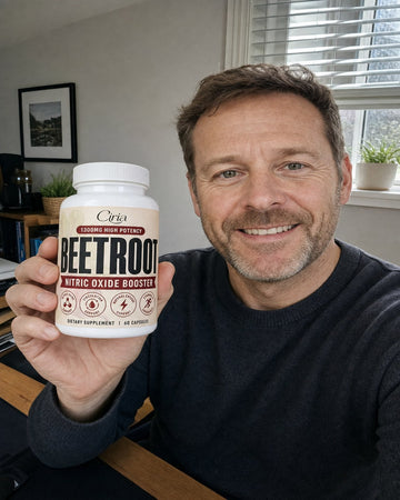 Man at a desk holding a bottle of Ciria Beetroot