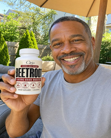 Man on a patio holding a bottle of Ciria Beetroot
