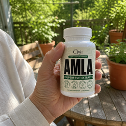 Ciria Amla Superfruit Extract held on a sunny garden patio